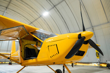 Yellow airplane glider in the hangar. 