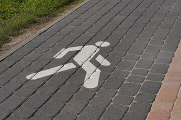 White painted markings for pedestrian and bicycle paths on the street
