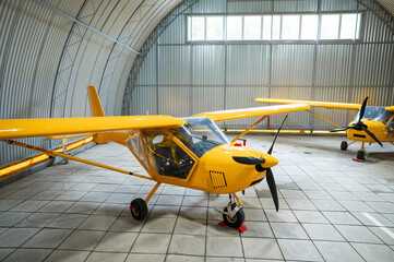 Yellow airplane glider in the hangar. 