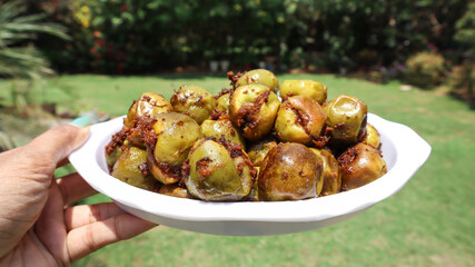 Traditional Indian sabji Lasuda ki sabji ot Glueberry curry stuffed with Indian spices masala on dish
