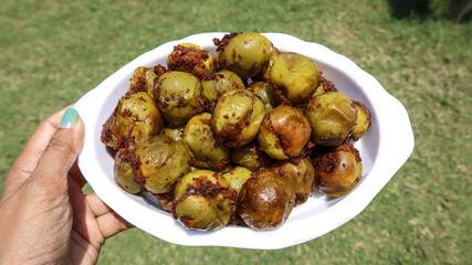Traditional Indian sabji Lasuda ki sabji ot Glueberry curry stuffed with Indian spices masala on dish