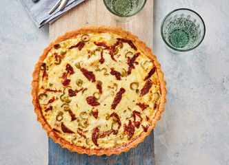 Savory Tart With Olives and Sundried Tomatoes on Wooden Surface Ready for Serving