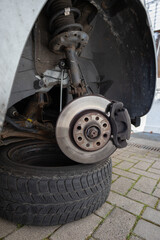 close up of man´s hands reparing the car. worker on the street lifting his car with the jack....