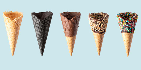 Various ice cream cones isolated on blue background. Banner design.