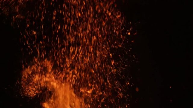 Falling Orange and Red Sparks and Particles - A vibrant cascade of fiery orange and red sparks and particles raining down, creating an energetic and dramatic effect, ideal for intense action scenes or
