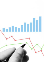 Conducting market analysis to increase sales in business, businessman's hand with pen analyzes...