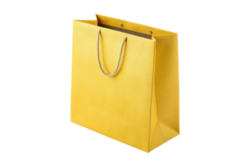 Elegant yellow paper shopping bag with gold rope handle isolated on transparent background