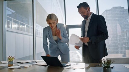Multitasking colleagues reviewing documents city office. Team examining papers - Powered by Adobe