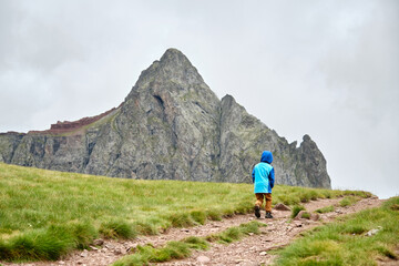 Fototapeta premium Young hiker with a mountain in the background