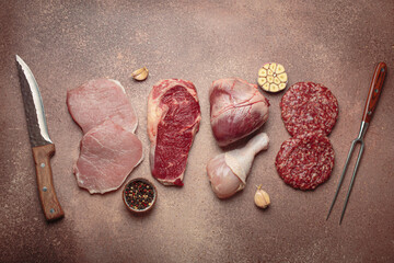 Selection of assorted raw meat cuts for zero carb carnivore diet: uncooked beef steak, pork, ground...