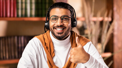 I Like E-Learning. Happy Indian Male Student Gesturing Thumbs Up To Camera Approving Educational...