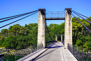 overground pedestrian steel cable metal crossing bridge walkway suspended by cables over the river for pedestrians