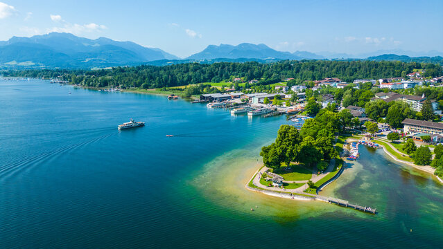 Aerial view of Prien am Chiemsee, a charming Bavarian town on the shore of Lake Chiemsee. Captured in summer, perfect vacation vibes with clear water, green landscapes, and sunny weather