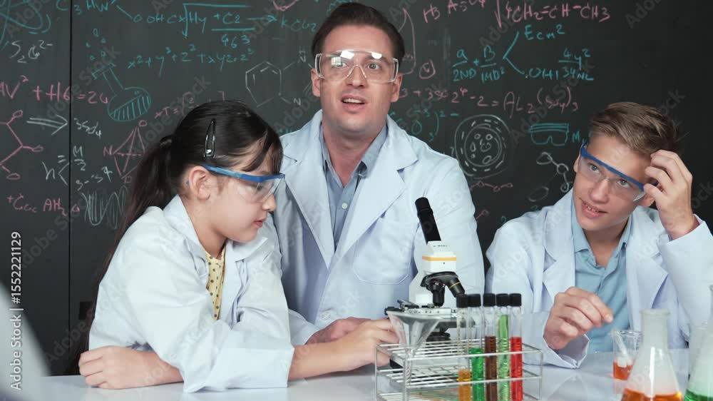 Poster smart teacher looking under microscope while test tube placed on table while diverse student doing e