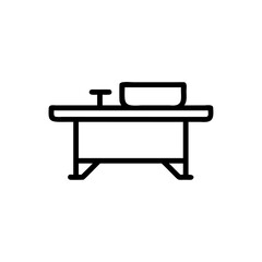 Line art of a workbench with a tool and a rectangular object on top against background