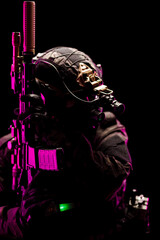 Special forces operative in tactical gear highlighted by vibrant lighting