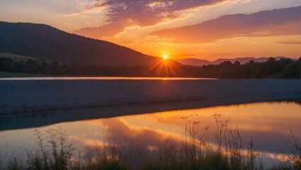 Fototapeta premium Sunset at reservoir with reflected sky and silhouettes of hills and vegetation.