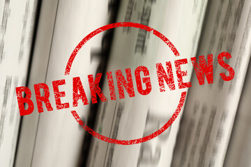 Red Breaking News stamp and newspapers as background, closeup