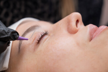 The process of professional eyelash lamination in a salon. 