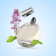 Bottle of floral perfume and blossoming lilac in air on light blue background