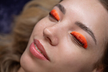 Caucasian woman undergoing eyelash lamination procedure. 