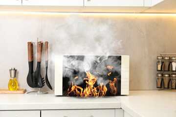 Microwave oven burning inside on countertop in kitchen