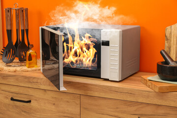 Microwave oven burning inside on countertop in kitchen