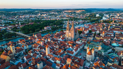 Regensburg at sunset captured from above, featuring the iconic Stone Bridge over the Danube River...