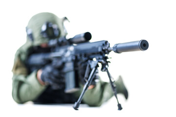 Close-up of a tactical soldier aiming a rifle with a suppressor