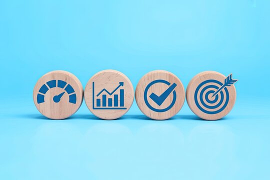 Four wooden blocks with blue icons representing performance growth success and goals on a bright blue background
