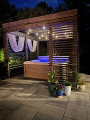 Gorgeous, luxury modern boho backyard design showcasing an outdoor pergola made from pine at...