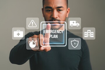 Man s finger touches a digital screen displaying the words emergency plan surrounded by icons for medical services and safety