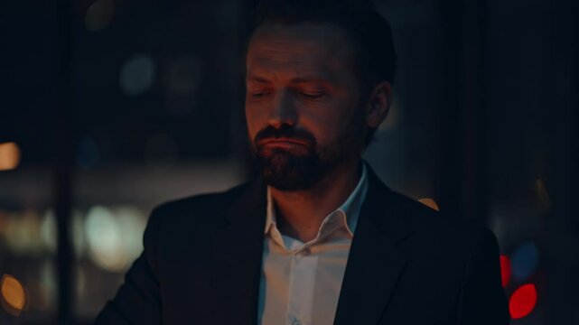 Portrait manager overworking late dark apartment. Exhausted ceo closing laptop