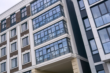 Modern apartment building with glass facade. Architectural details of modern building.