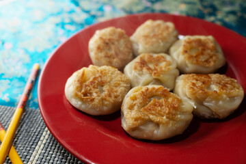 Food preparation scene with dumplings and natural light – cultural tradition