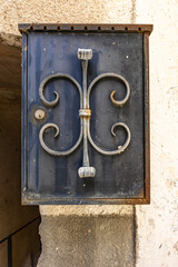 Decorative metal mailbox mounted on a stone wall

