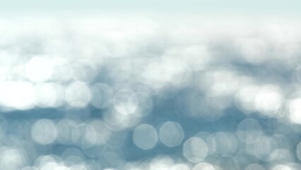 Blurred light blue background round bokeh with sparkling sunlight and shimmering sun glare on blue...