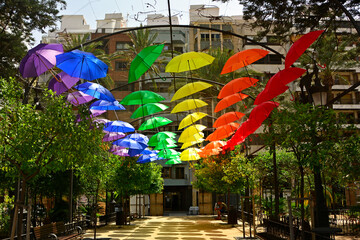 kolorowe parasole wiszące w mieście podczas parady równości, symbol LGBT, Colorful decorative umbrellas, rainbow umbrellas hanging around the city during the pride parade, lgbt umbrellas
