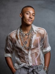 Confident young woman with short hair wearing layered jewelry and a sheer shirt, stylish fashion portrait