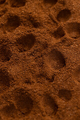 brown ground coffee , an abstract uneven ground coffee bean background for making a high-quality and aromatic coffee drink