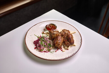 Grilled meat with onion salad and sauce