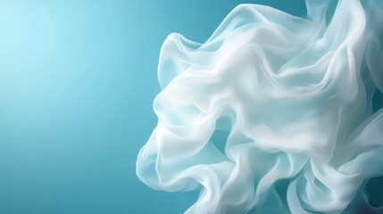 Obraz premium An elegant image of softly flowing white fabric against a serene blue backdrop, evoking feelings of tranquility and fluidity. The lightness represents elegance and artistic grace.