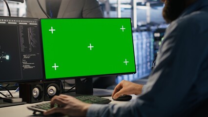 Engineer using green screen mockup PC in data center to update servers tech, configuring equipment...