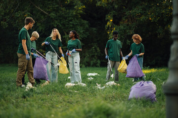 Group of volunteers picking up trash in park