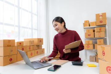 Asian Woman Running Online Business from Home