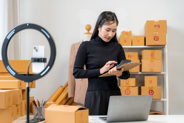 Asian Woman Managing Online Business at Home