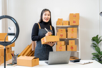 Asian Woman Packaging Orders for Online Business