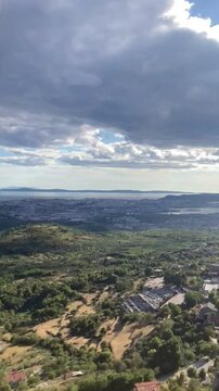 View from the top of the mountain by the Adriatic sea on the forest and a narrow road for cars at sunset on vacation in Croatia near the city of Split
