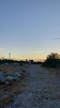 View from the top of the mountain by the Adriatic sea on the forest and a narrow road for cars at sunset on vacation in Croatia near the city of Split