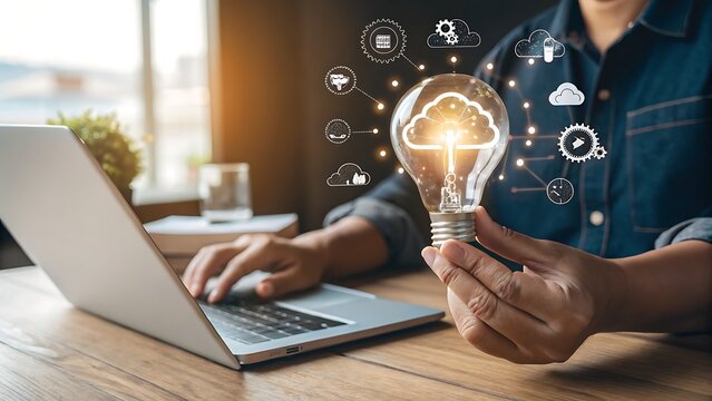 Photo of person holding a glowing lightbulb with cloud computing icons